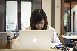 student with laptop studying